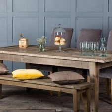 A Small Round Dining Table And Its Matching Chairs